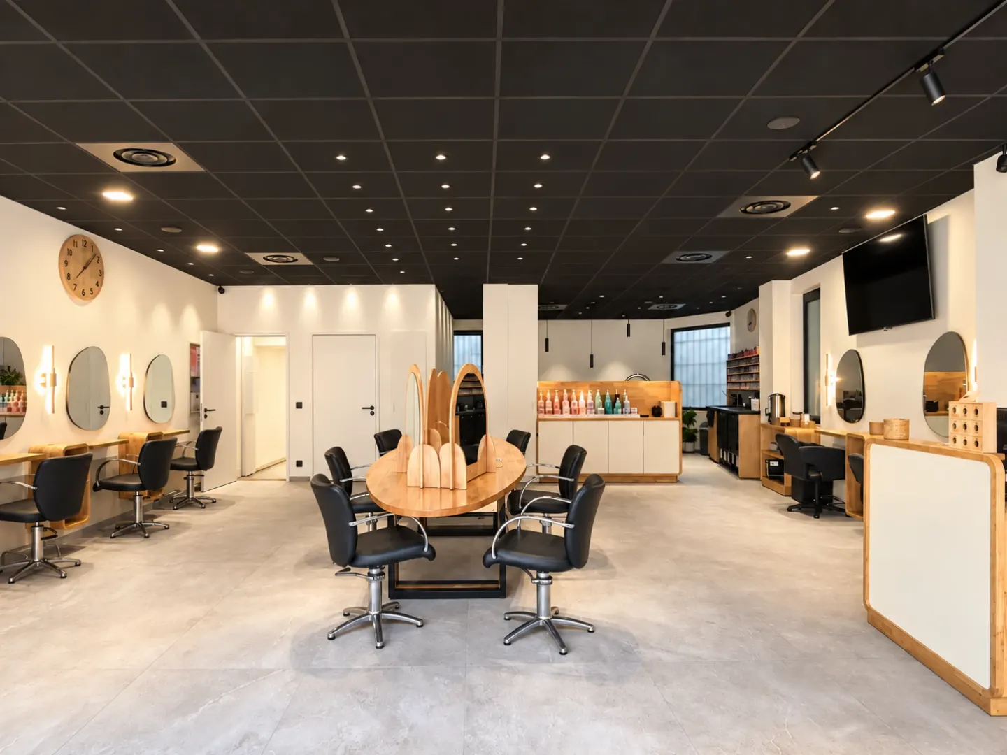 Cagnes-sur-Mer salon: large oval wooden table in the centre, arched mirrors and black ceiling