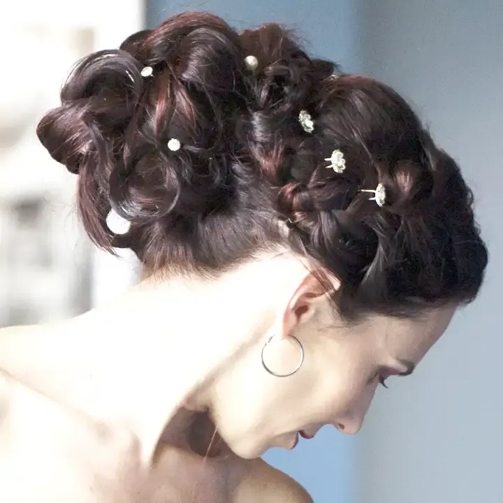 Brown bridal updo styled in curls, set with small jewels