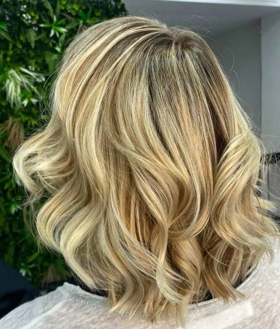 Blonde balayage on wavy mid-length hair