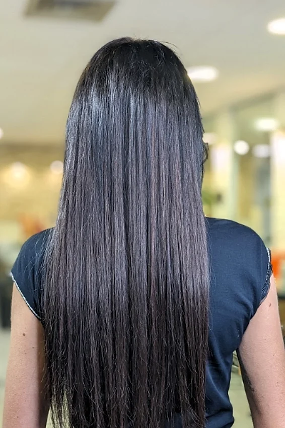 After: long, straight black hair with extensions
