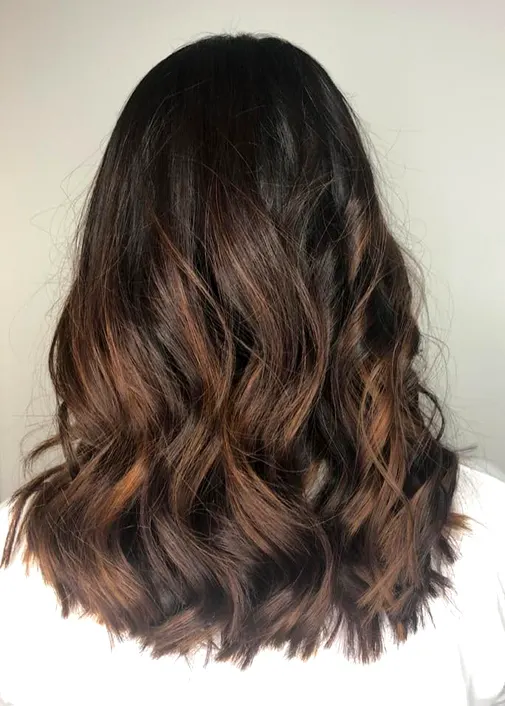 Strobing: subtle bright highlights on long wavy hair