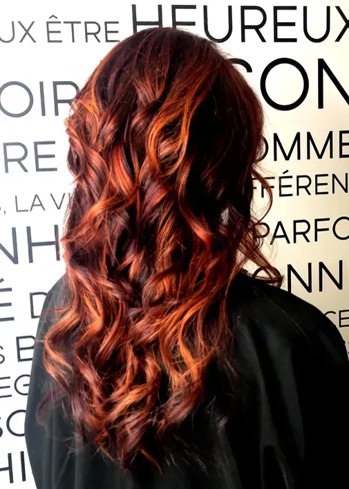 Tiger eye: alternating shadow and copper light on long curly hair