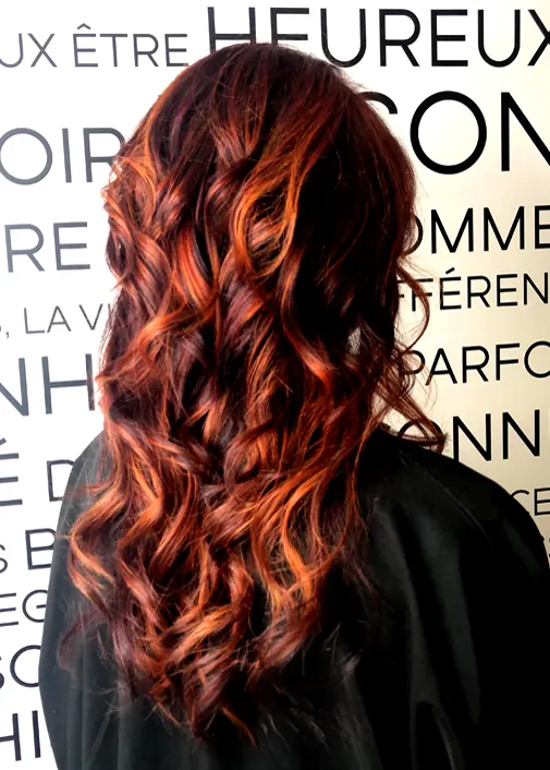 Tiger eye: alternating shadow and copper light on long curly hair