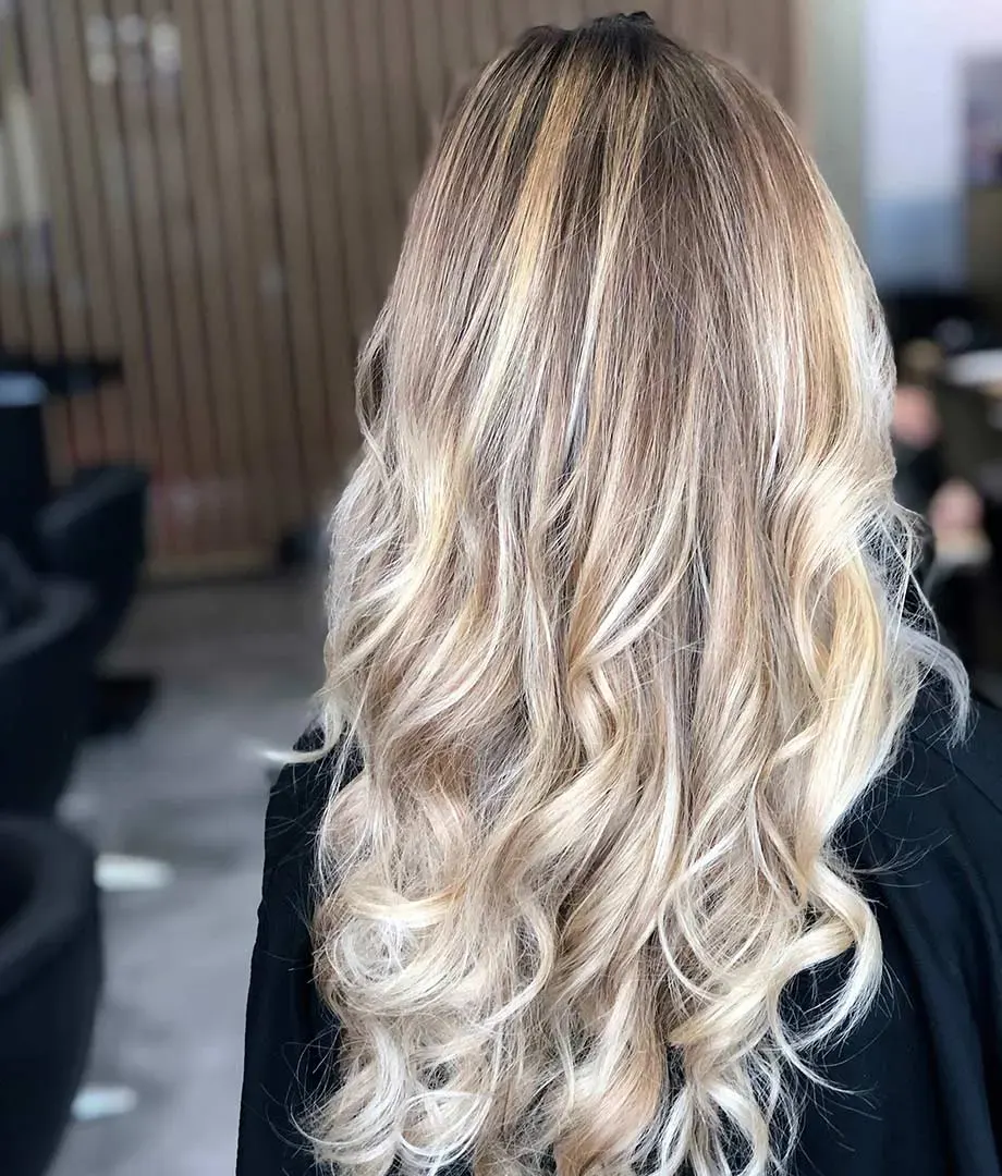 Platinum blonde highlights on long curly hair